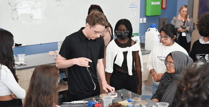  A scientist demonstrating an experiment with students.