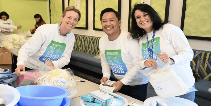  Three employees posing during an event at Regeneron’s annual Day for Doing Good.