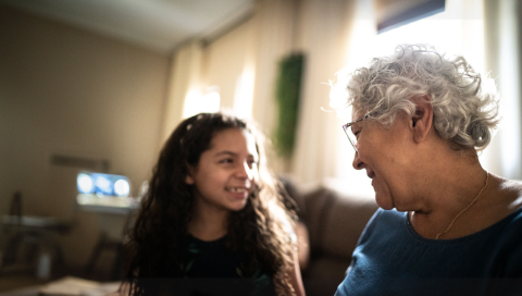 An elderly woman talking to her grandchild.