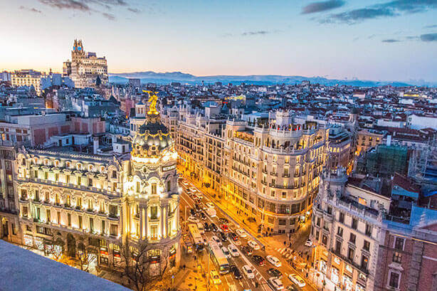 Regeneron location in Madrid, Spain. Skyline of Madrid with a view of a busy street.